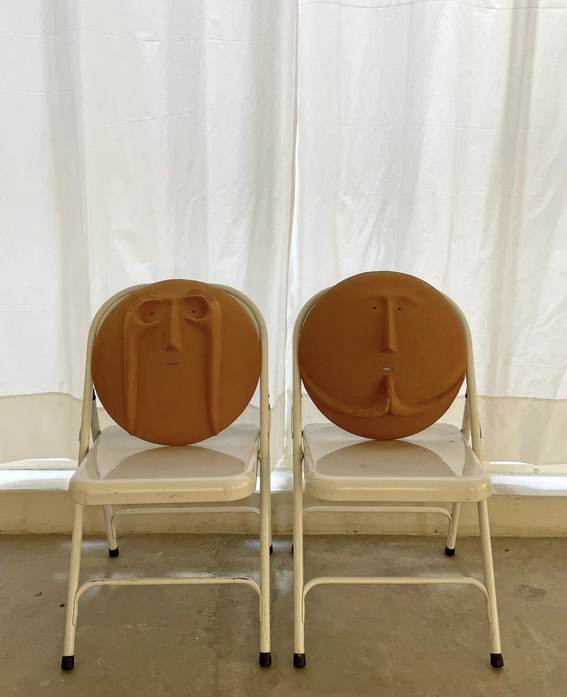 Sculptures of faces used as seat cushions